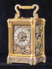 A exceptionally fine carriage clock in muti-coloured relief work