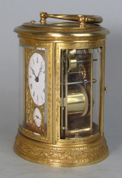 An engraved oval carriage clock