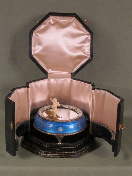 Silver and enamel novelty clock with rotating figure to show the time.    