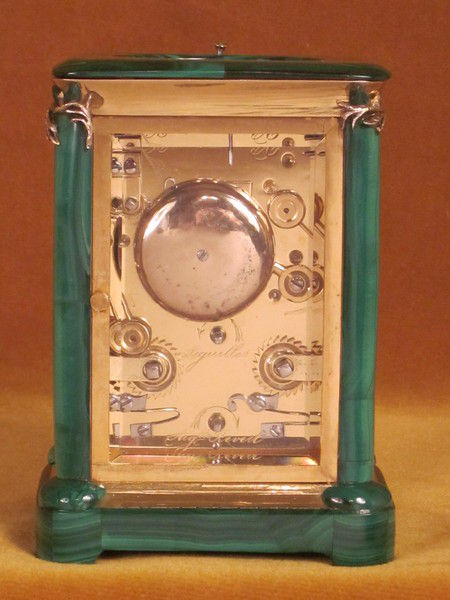 A French carriage clock almost completely covered with solid malachite
