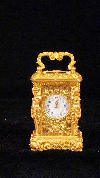 Miniature carriage clock with carytids, engraved panels and original case.  