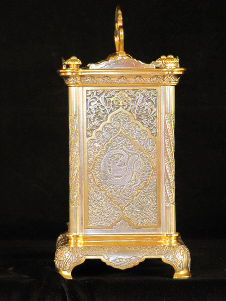 The Basilisk carriage clock, with very finely decorated metal panels. 