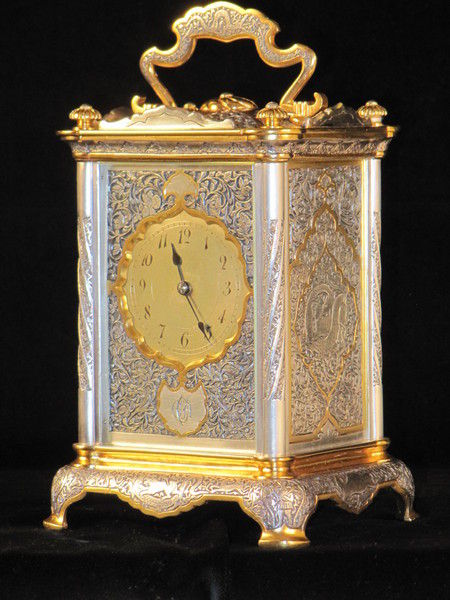 The Basilisk carriage clock, with very finely decorated metal panels. 