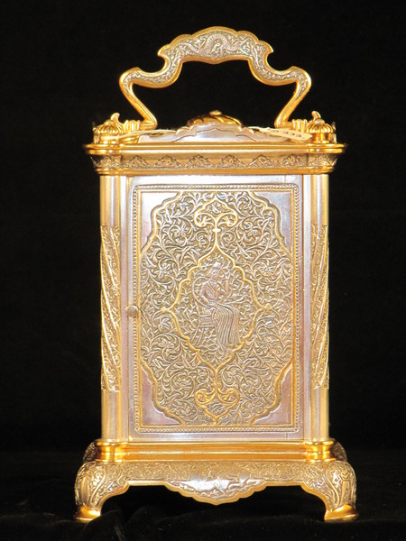 The Basilisk carriage clock, with very finely decorated metal panels. 