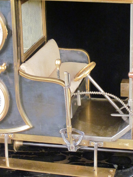 A rare automaton car clock by Guilmet, 