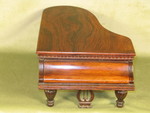 Miniature rosewood necessaire in form of a grande piano, with music box (England)